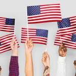 Photo of hands holding American flags
