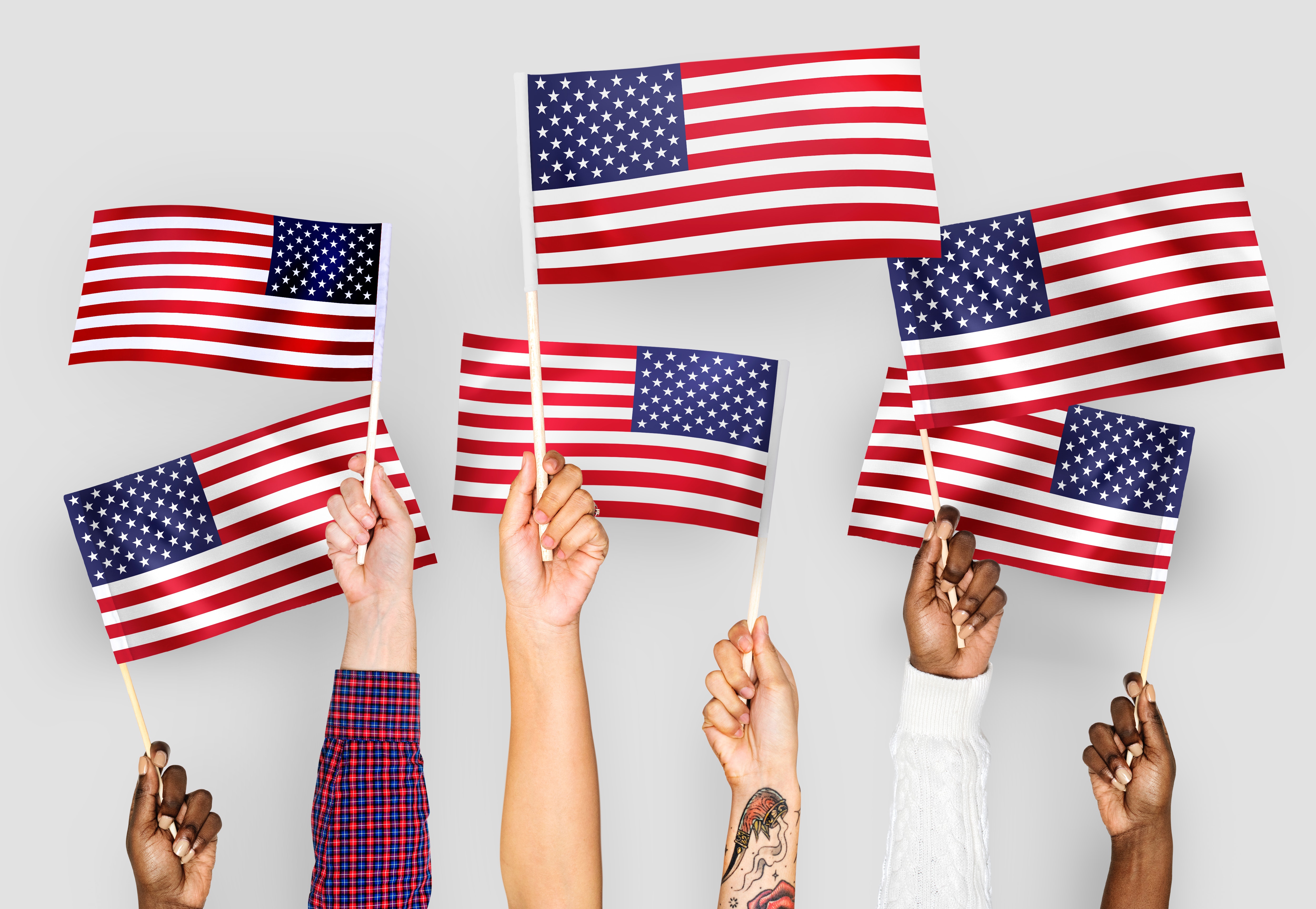 Photo of hands holding American flags
