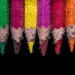 Photo of colored pencils underwater with air bubbles