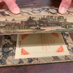 Photo of a book with a painted edge scene