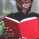 Photo of a man reading a book