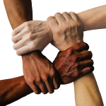 Image of people with different colored skin holding hands