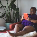 Woman on a couch using an iPad