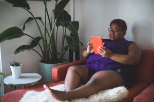 Woman on a couch using an iPad
