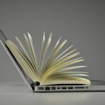 image of a laptop and a book