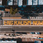 Photo with End Racism Now written on a street
