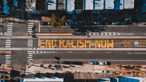 Photo with End Racism Now written on a street