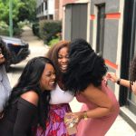 A joyful group of friends sharing a moment of laughter on a sunny day outdoors