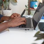 Photo of a person typing on a laptop