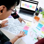 UX folks discussing wireframes.
